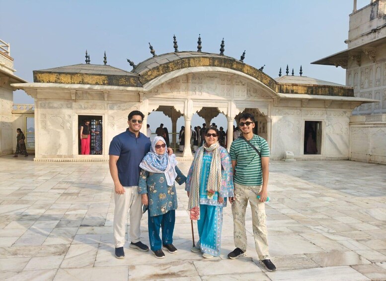 A group of people standing in front of a historic building with domed roofs and intricate architectural details. 5