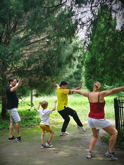 A group of people practicing martial arts outdoors. 5