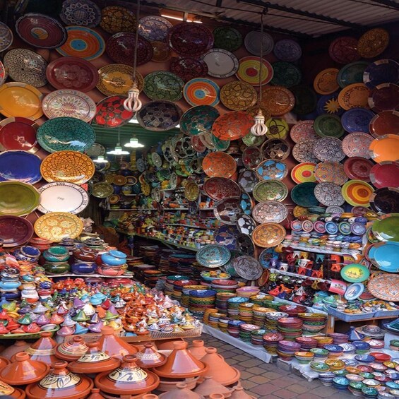 A vibrant market stall with a variety of colorful pottery and ceramics. 5