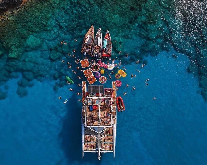 An aerial view of a floating platform with people and boats. 3