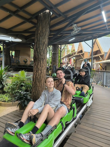A wooden boardwalk with a tree and a green vehicle. 4