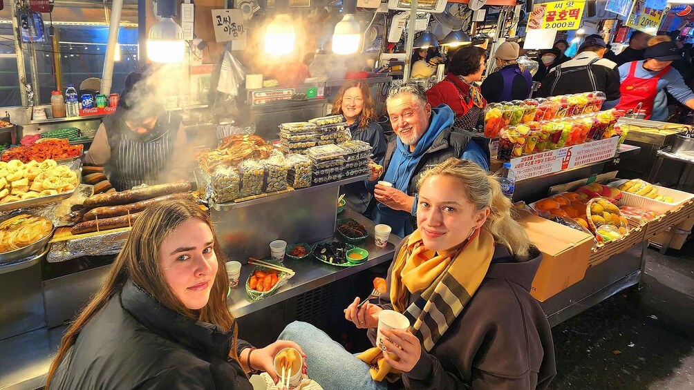 A bustling street food market with various food stalls and vendors. 2