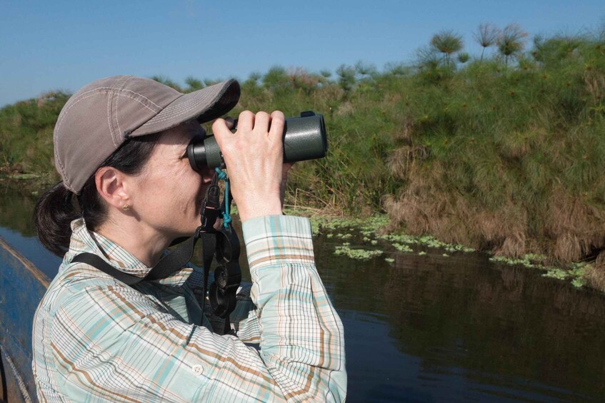 A person taking a photograph with a camera. 1