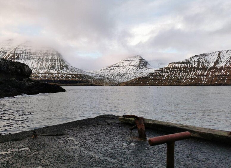 A lake with snow-covered mountains in the background. 2