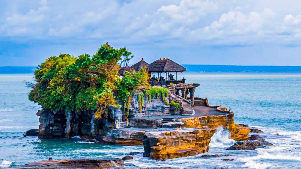 A rocky island with a gazebo and a staircase leading to a small platform. 5