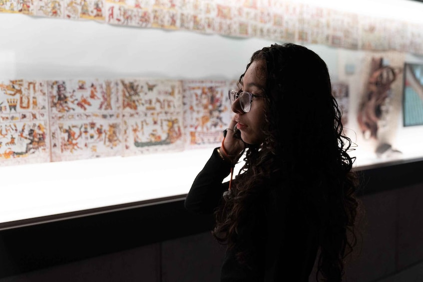 A person standing in front of a display with various colorful illustrations. 3