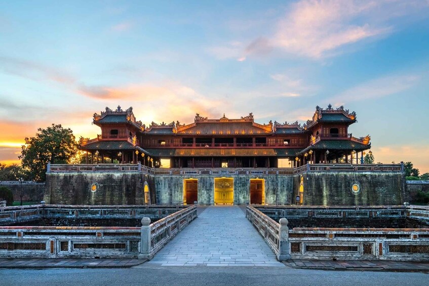 A traditional Chinese building with a symmetrical facade, a central entrance, and a stone pathway leading to it. 1