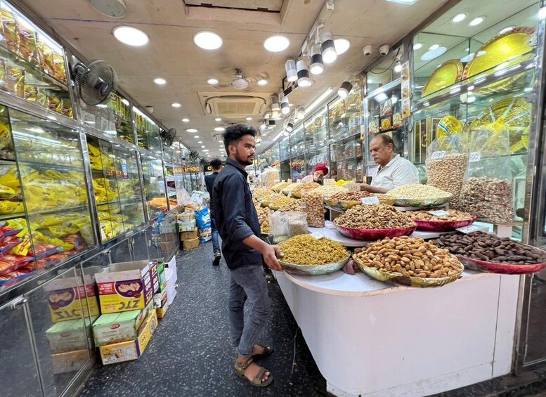A market aisle with various food items displayed in glass cases and on counters. 5