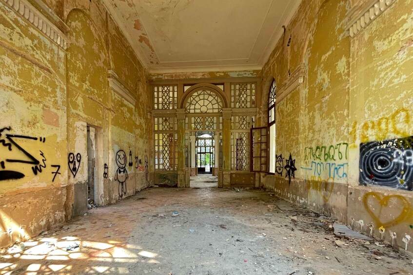 An abandoned building with graffiti on the walls and floor. 2