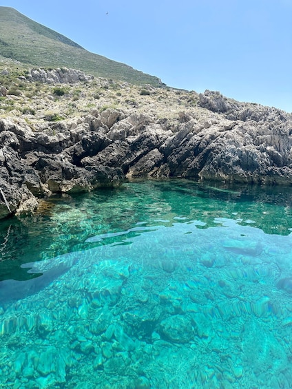 A rocky shoreline with clear turquoise water. 3
