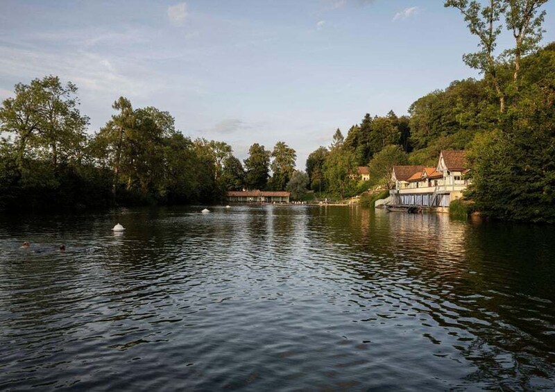 A calm river with a house on the right bank and trees on the left. 2