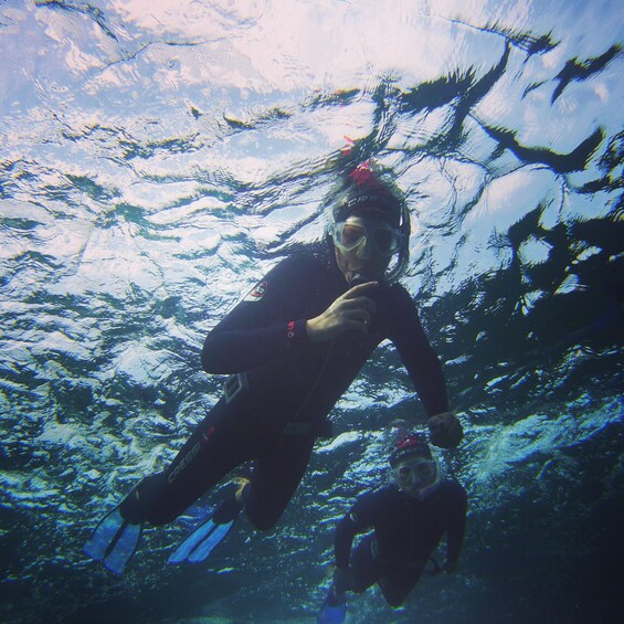 A person scuba diving underwater. 2