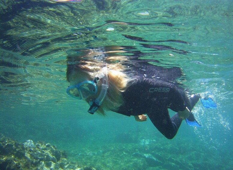 A person underwater with a snorkel and fins. 1