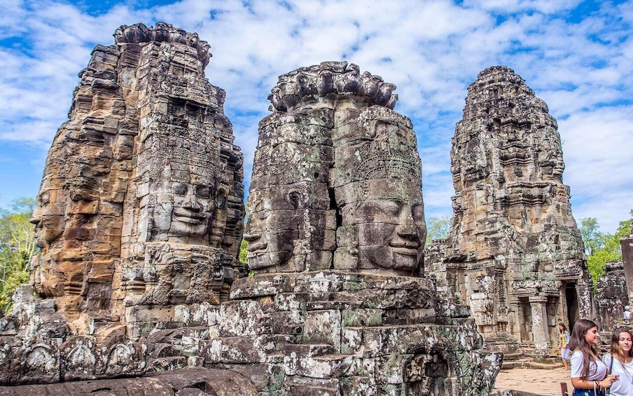 Ancient stone structures with intricate carvings and faces. 1