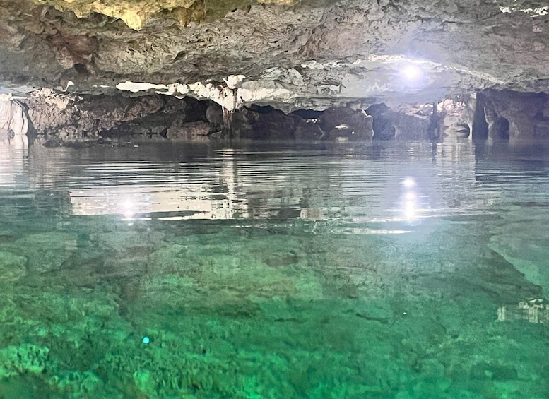 A cave with clear water and rock formations. 5