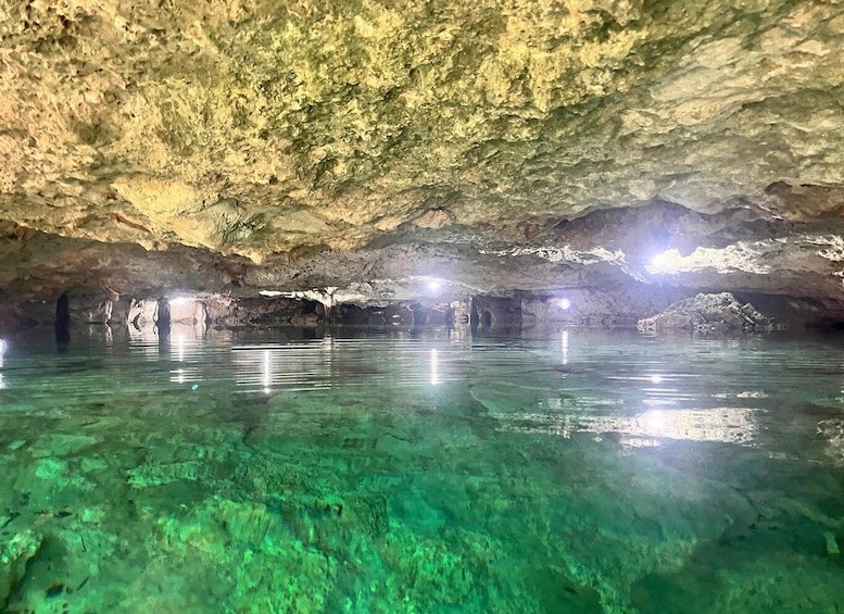 A cave with clear water and stalactites. 2