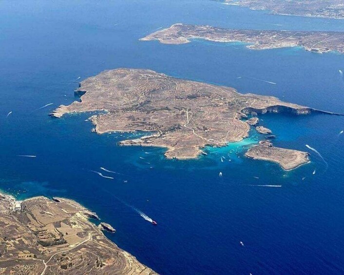 An aerial view of a coastal region with multiple islands, clear blue waters, and visible roads and buildings. 4