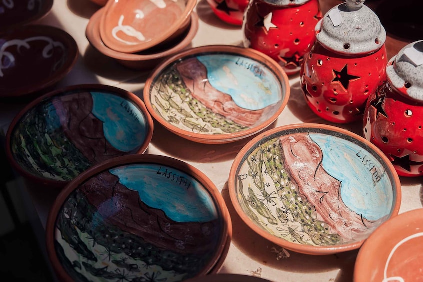 Various ceramic bowls with painted landscapes and the name 'LASSITHA' on them. 4