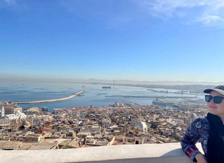A coastal cityscape with a clear view of the sea, a bridge, and a dense urban area. 4
