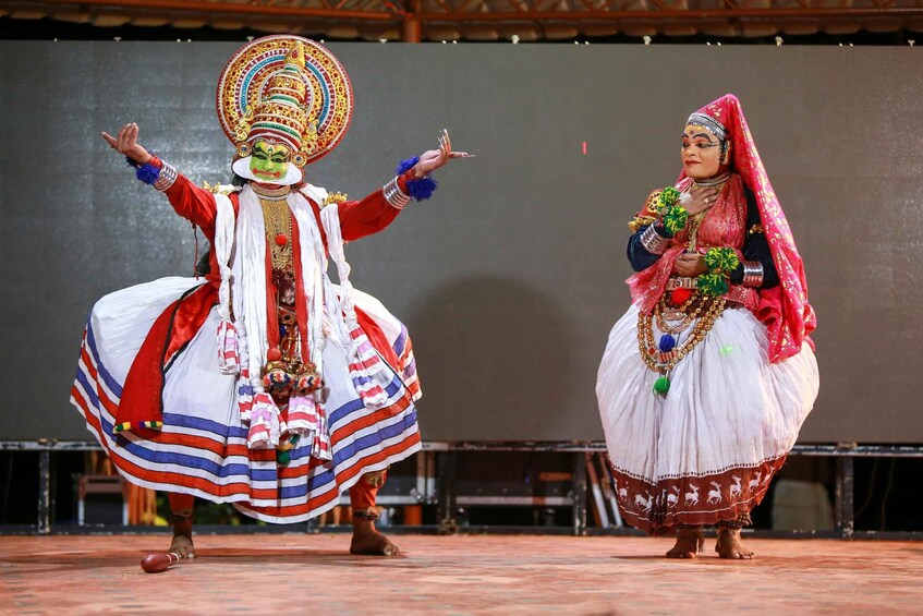 Two performers in traditional costumes on a stage. 1