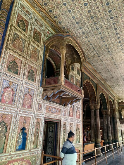 A richly decorated interior with intricate patterns and arches. 5