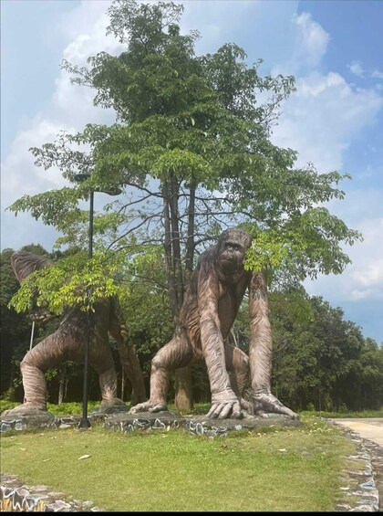 A large sculpture of a gorilla with a tree behind it. 4