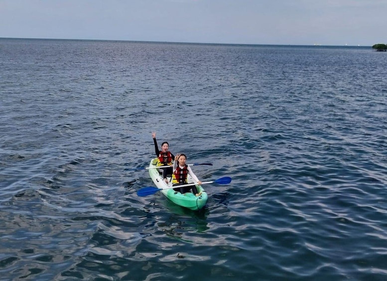 Two people kayaking on a calm sea. 5
