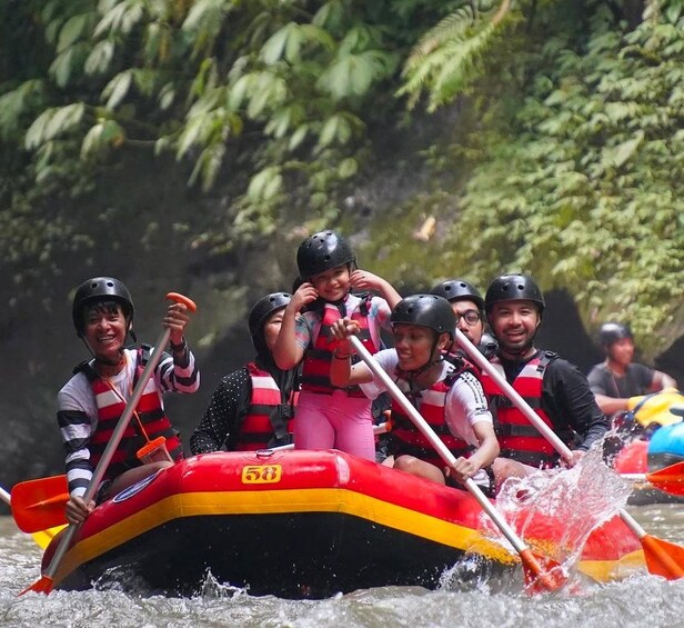 A group of people in a raft navigating through a river surrounded by dense foliage. 5