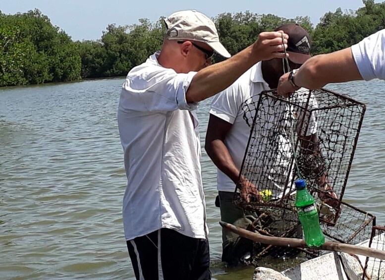 Two people handling a fishing trap on a boat. 3