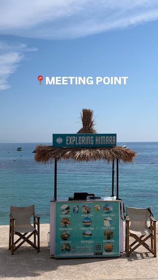 A beachside kiosk named 'Exploring Himara' with a signboard listing local attractions like Gramma Bay and Pigeon’s Cave. 3