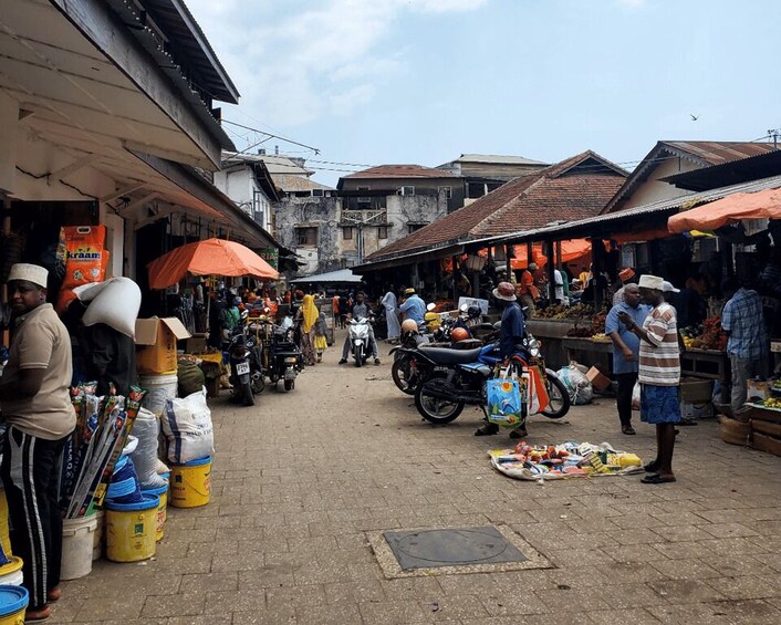 A bustling street market with vendors and shoppers. 3