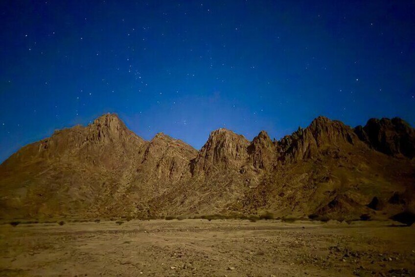 A starry night sky over a mountainous landscape. 5