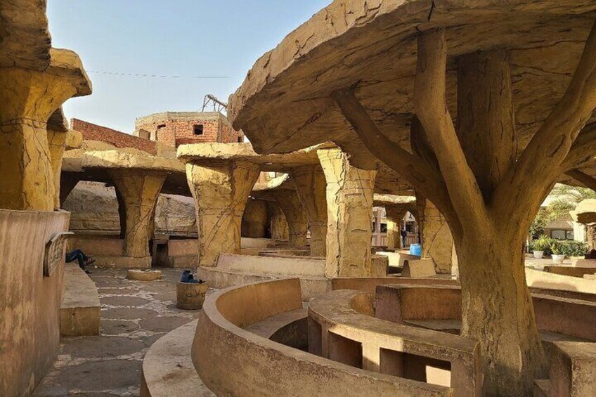 A traditional building with large stone supports and circular seating areas. 2