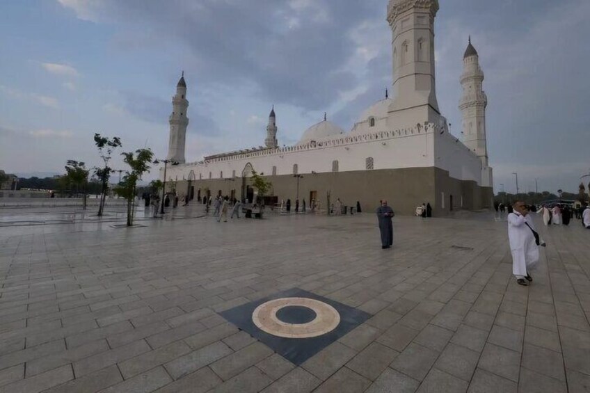 A large mosque with two minarets and a courtyard. 5