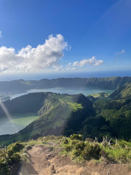 A mountainous landscape with a lake and a winding road. 1