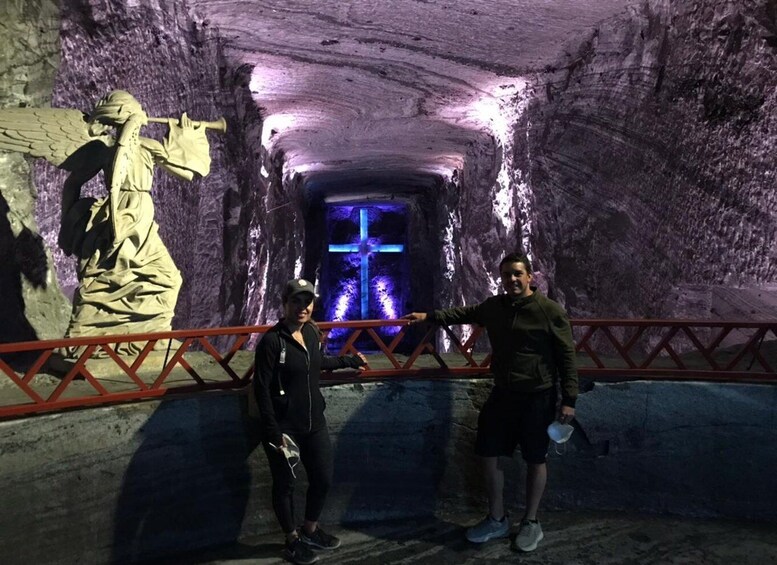 A cave with a statue and a cross. 3
