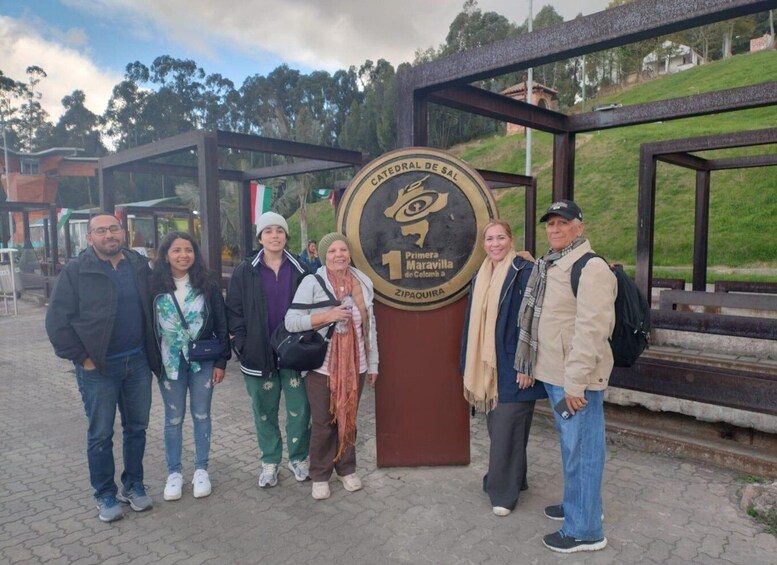 A group of people standing in front of a sign that reads "Catedral de Sal Primera Maravilla de Colombia." 4