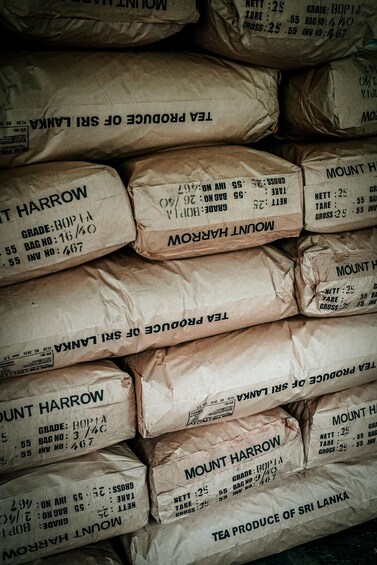 Stacks of bags labeled 'Mount Harrow' and 'Tea Produce of Sri Lanka'. 2