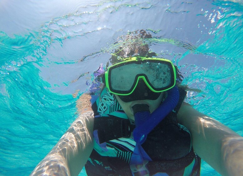 A person snorkeling underwater with a snorkel and mask. 5
