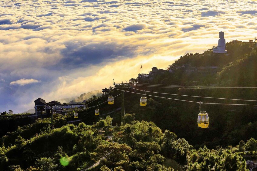 A cable car system, a statue, and a mountainous landscape with clouds. 4