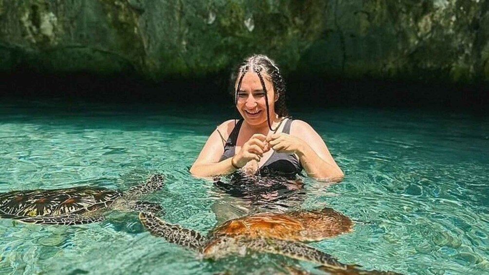 A person in clear water with a sea turtle. 3