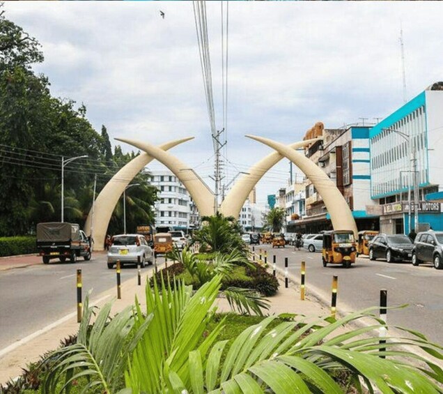 A busy urban street with a distinctive archway structure. 2