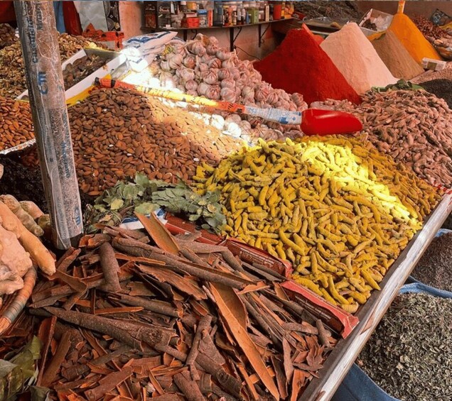A market stall with various spices and herbs displayed in piles. 1