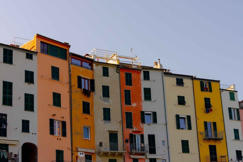 A row of colorful buildings with balconies and windows. 5