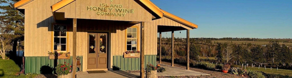 A wooden building with a sign reading "Island Honey Wine Company." 3