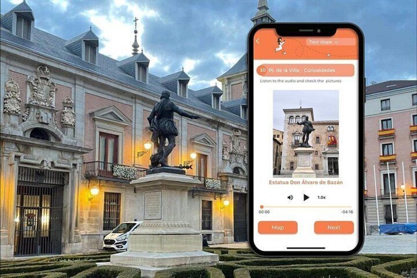 A smartphone displaying a tour guide app with a statue in front of a historic building. 3