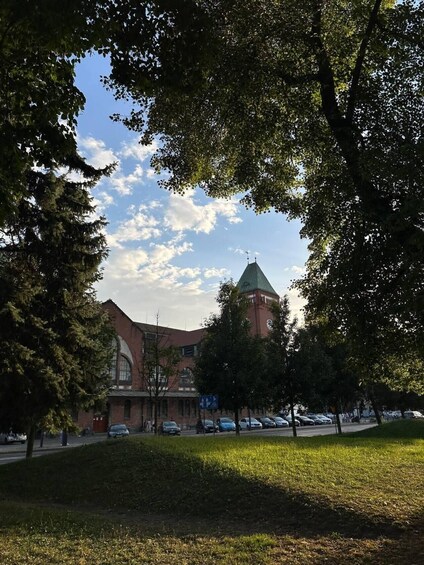 A church with a tower, surrounded by trees and a grassy area. 3