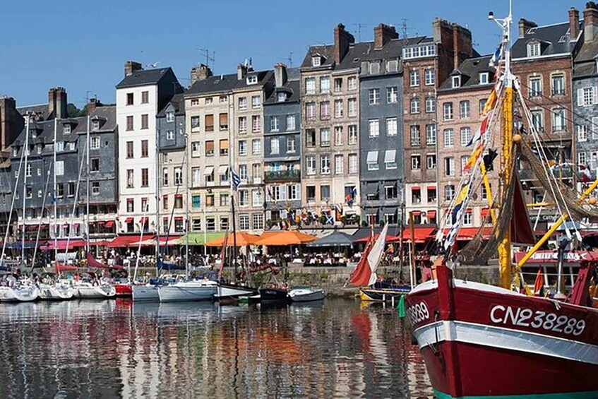 A harbor with boats, colorful buildings, and flags. 3
