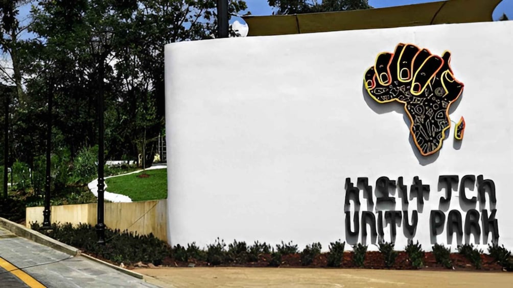A Unity Park sign with a raised fist graphic and the name 'Unity Park' in bold letters. 2