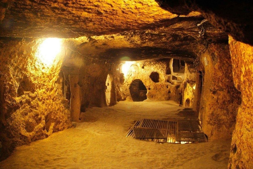 A cave with a central stone structure and a light source. 2